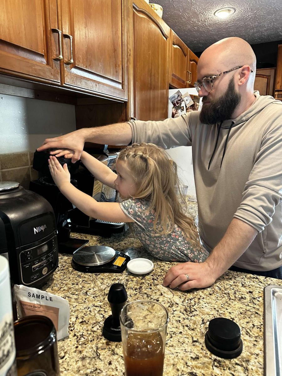 Brandon Shover helps his daughter Della make coffee