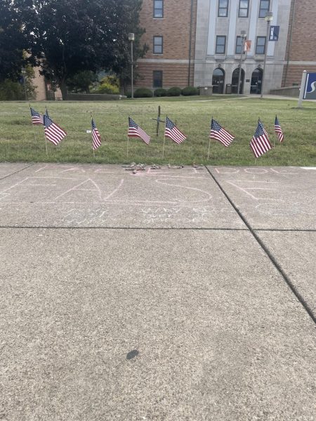 Messages chalked on a campus walkway last week in front of a memorial to Charlie Kirk