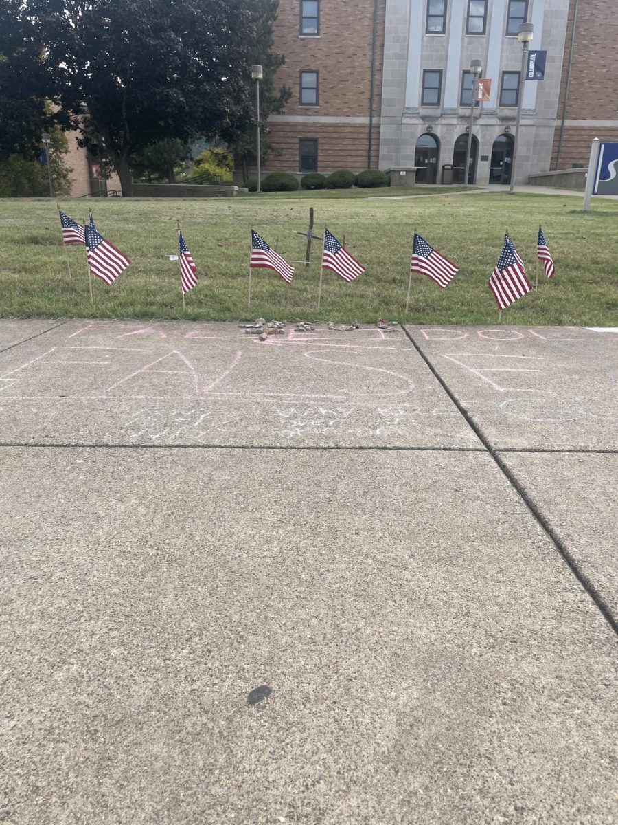 Messages chalked on a campus walkway last week in front of a memorial to Charlie Kirk